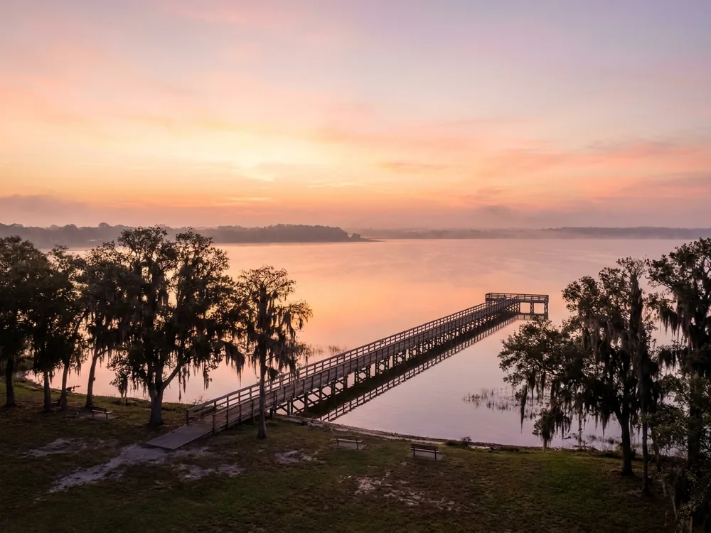 Fishing pier on East Lake Tohopekaliga at sunrise in St. Cloud